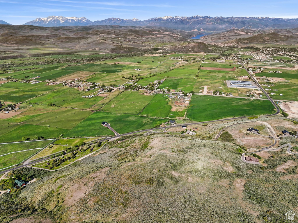 Aerial view of property's location featuring a mountain backdrop