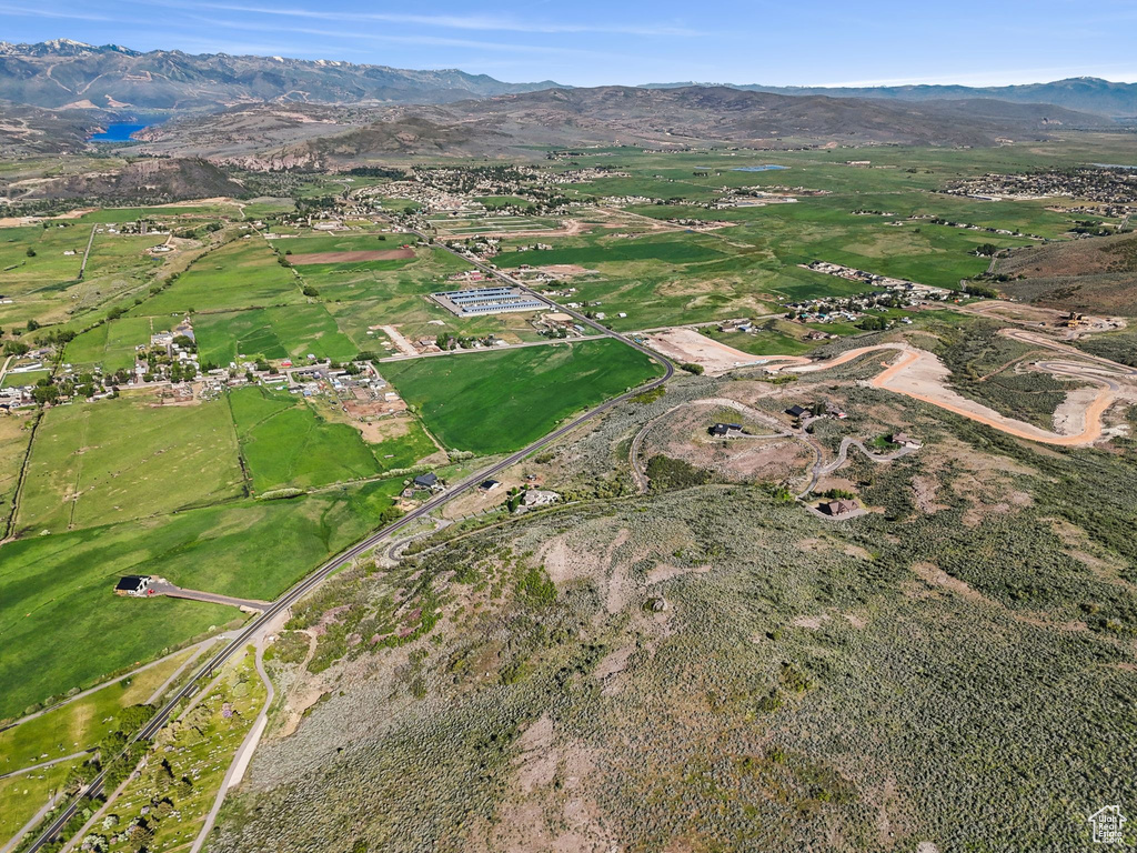 Aerial view of property and surrounding area with mountains
