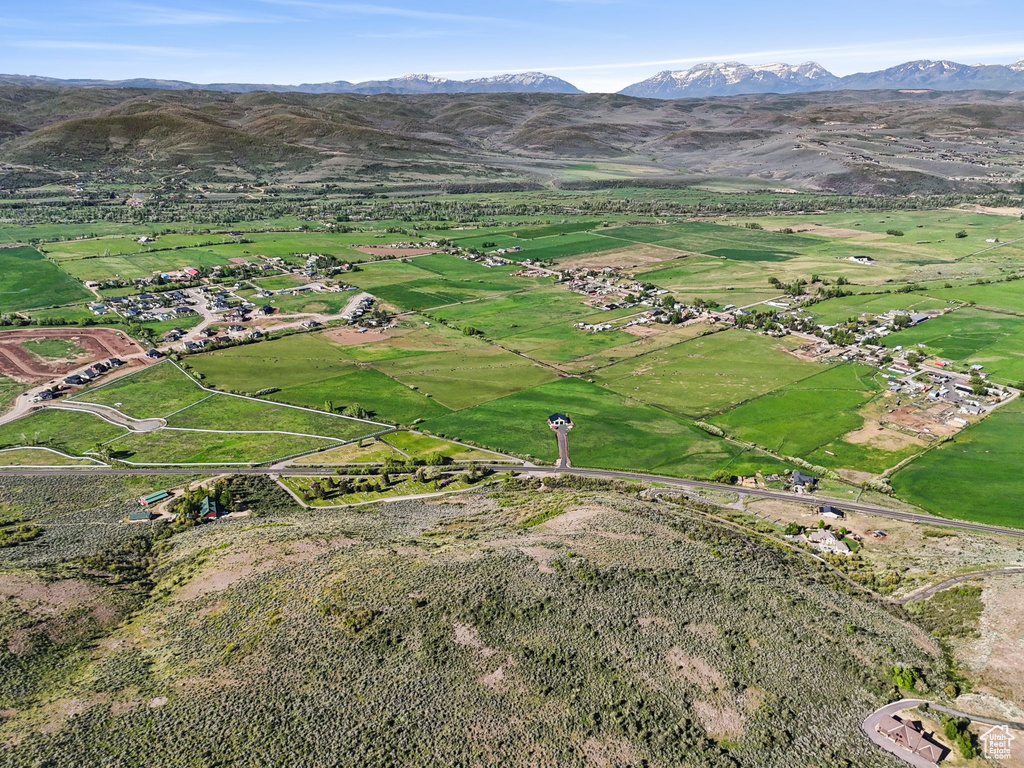 Aerial view of property's location featuring a mountain backdrop