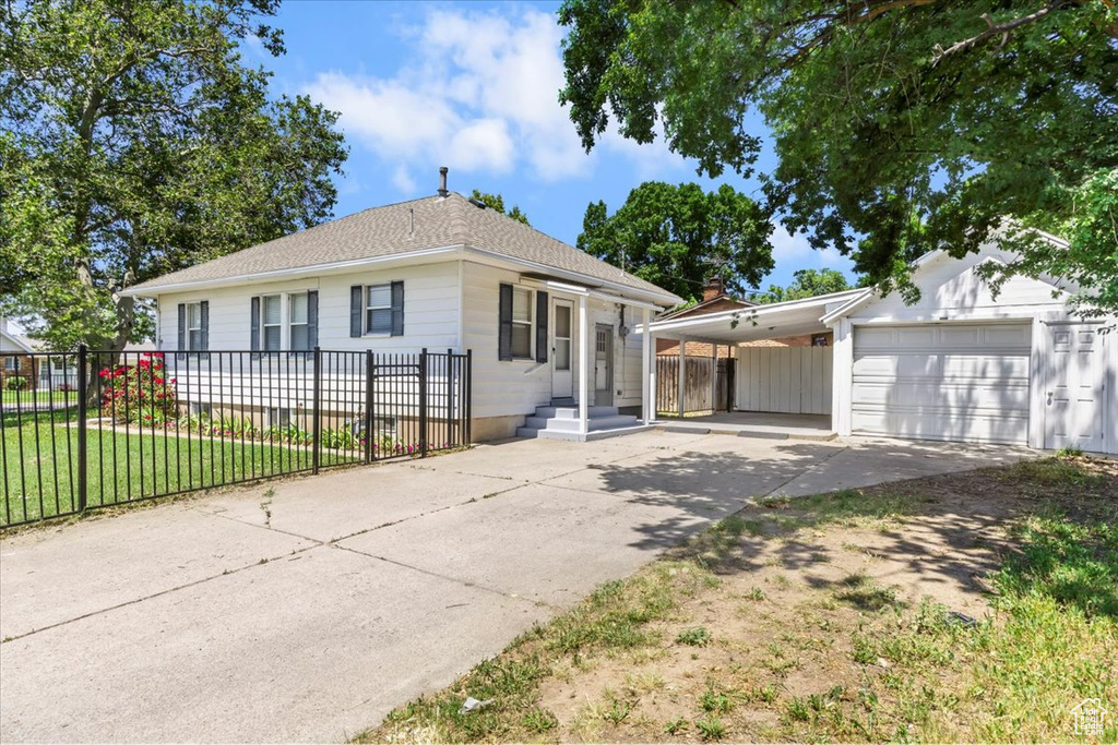 Single story home with concrete driveway and a shingled roof