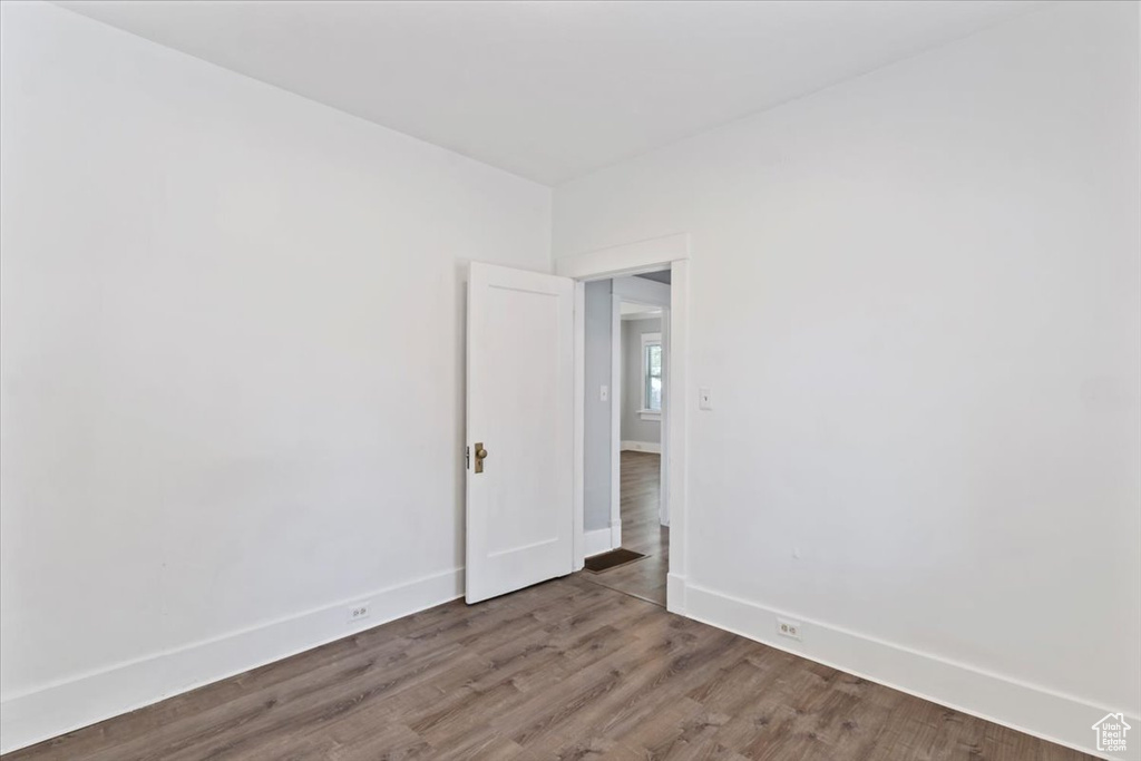 Empty room featuring baseboards and wood finished floors