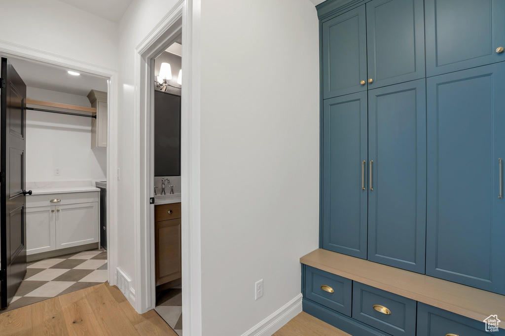 Mudroom with a sink and light wood-style floors