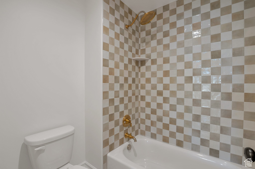Full bath featuring toilet and bathtub / shower combination