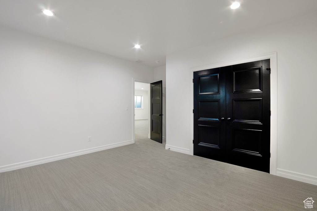 Unfurnished bedroom with carpet flooring, baseboards, and recessed lighting
