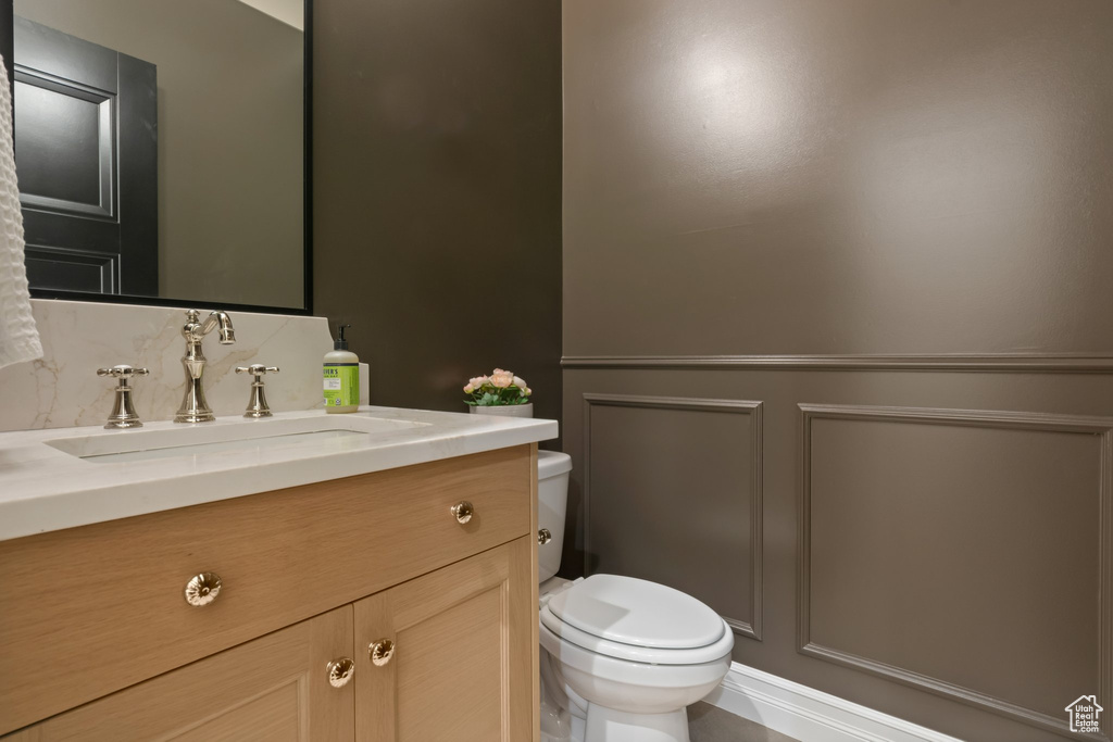 Half bath featuring toilet and vanity