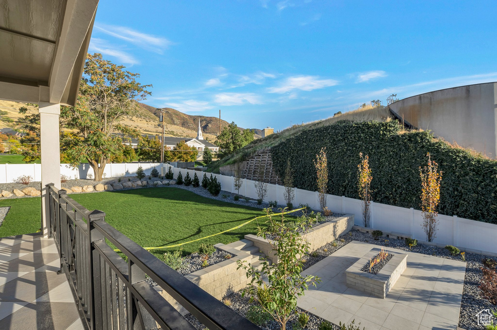 View of yard featuring a patio area, a mountain view, and a fire pit