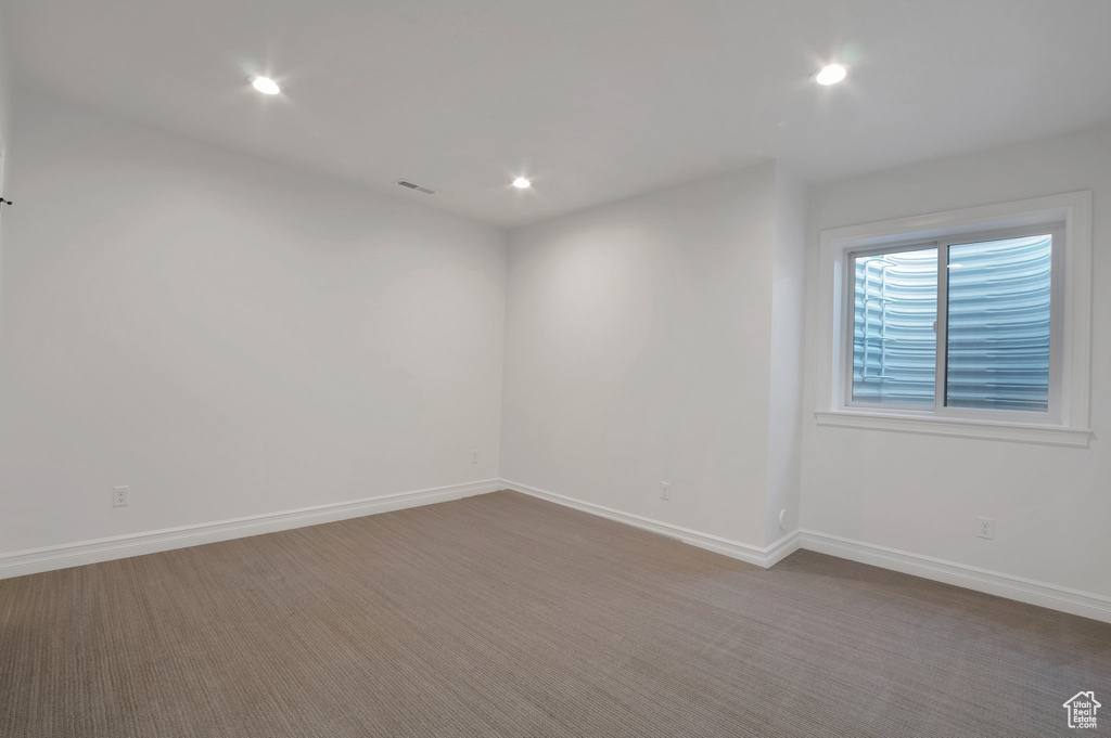 Unfurnished room featuring baseboards, recessed lighting, and carpet floors