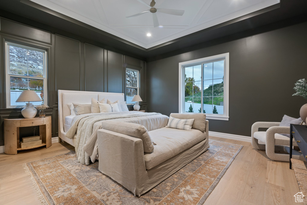 Bedroom with light wood finished floors, recessed lighting, a decorative wall, a ceiling fan, and baseboards