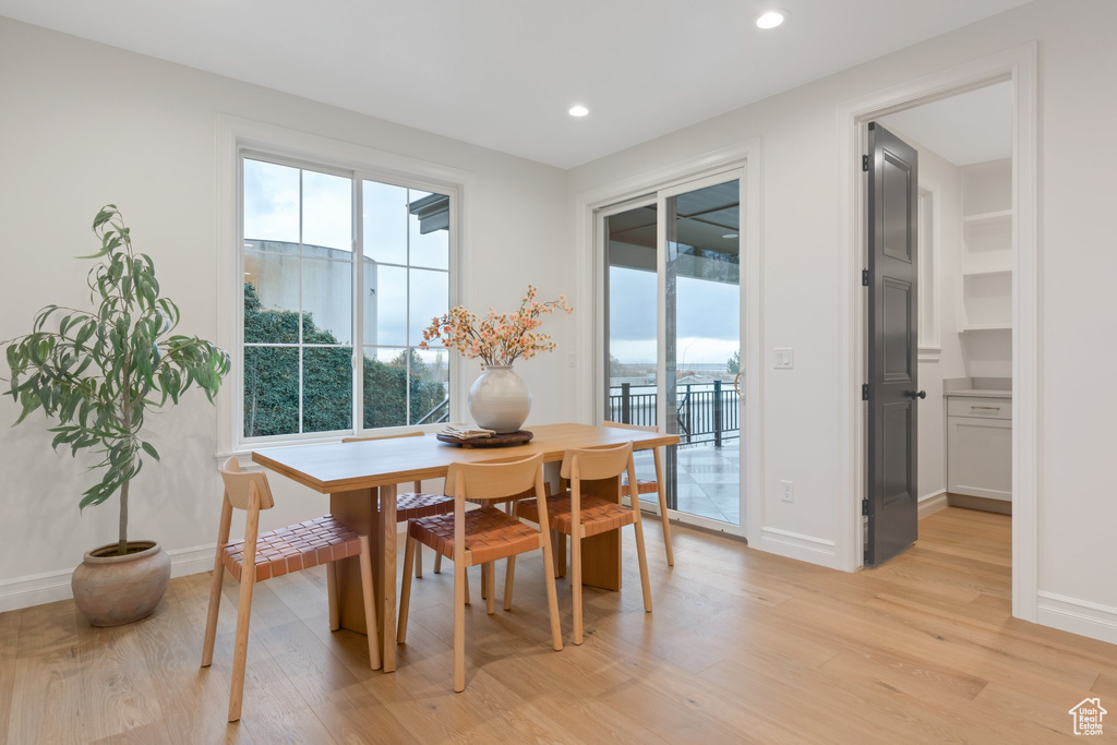 Dining space featuring healthy amount of natural light, light wood-type flooring, recessed lighting, and baseboards