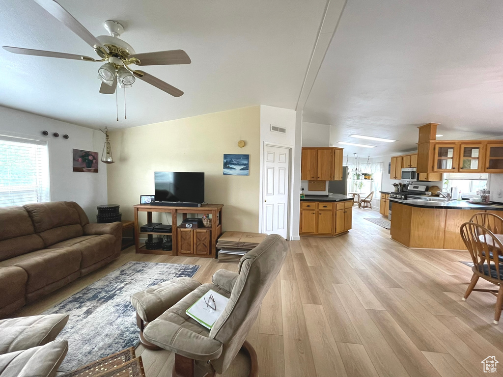 Living room featuring light wood-type flooring and ceiling fan