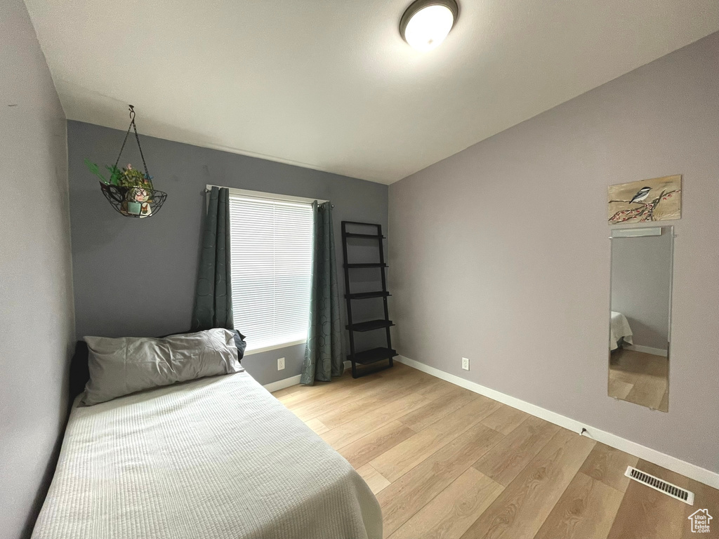 Bedroom with light wood-style floors and baseboards