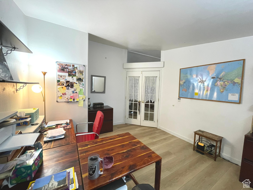Office featuring wood finished floors, french doors, and baseboards