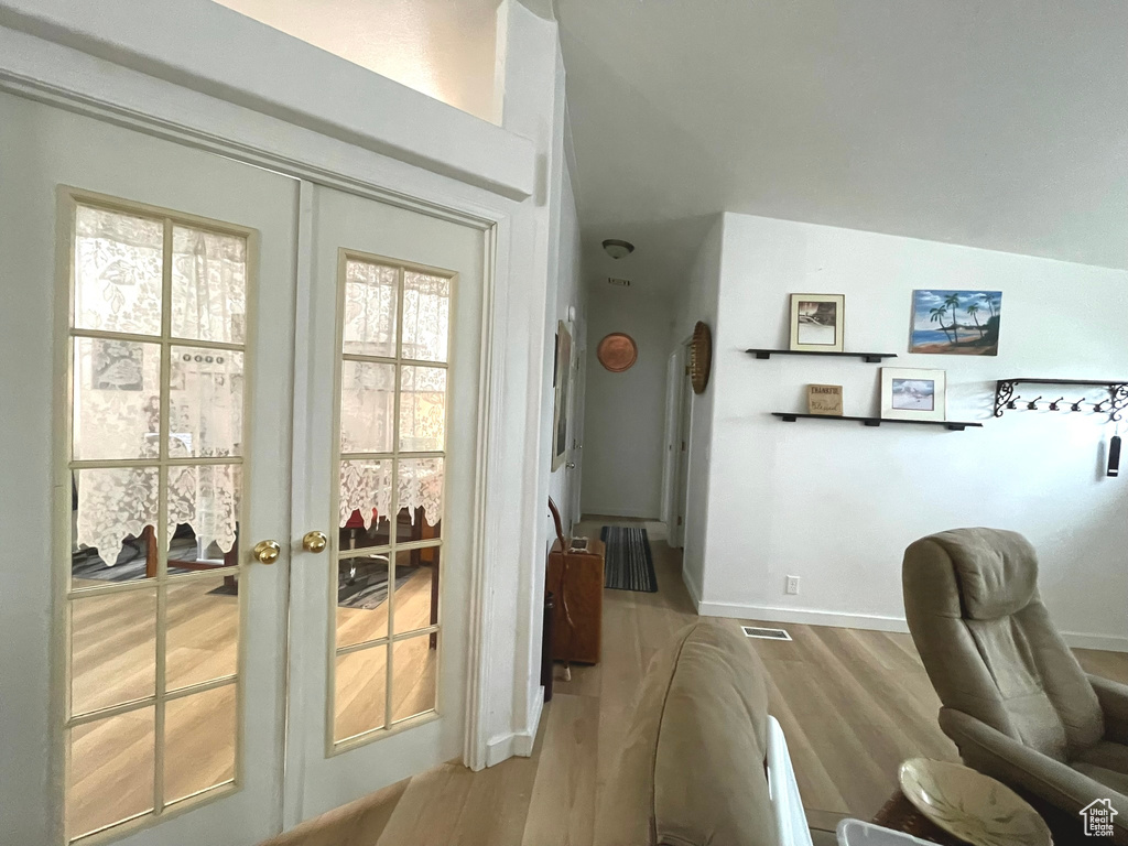 Office area with wood finished floors, french doors, and baseboards