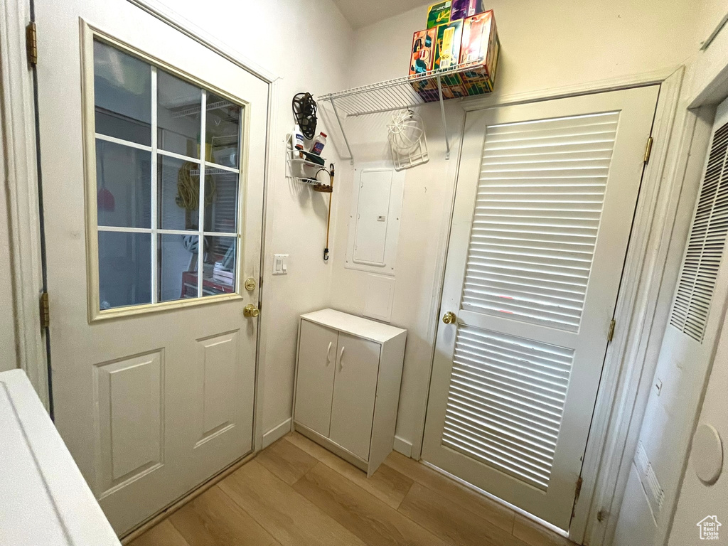 Entryway with light wood-style flooring and a heating unit