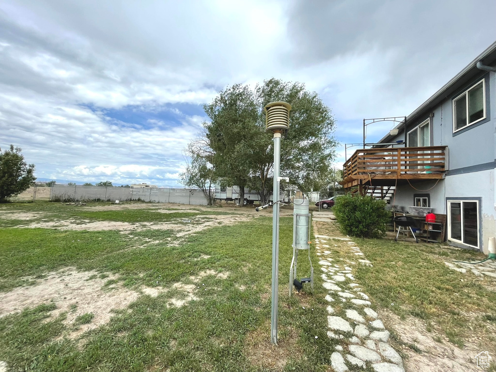View of yard with a wooden deck