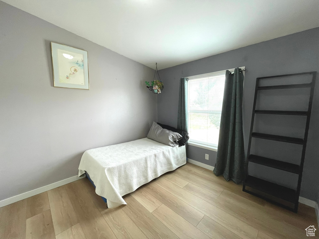 Bedroom with light wood-style floors and baseboards
