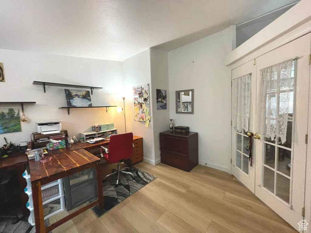 Office with wood finished floors, french doors, and baseboards