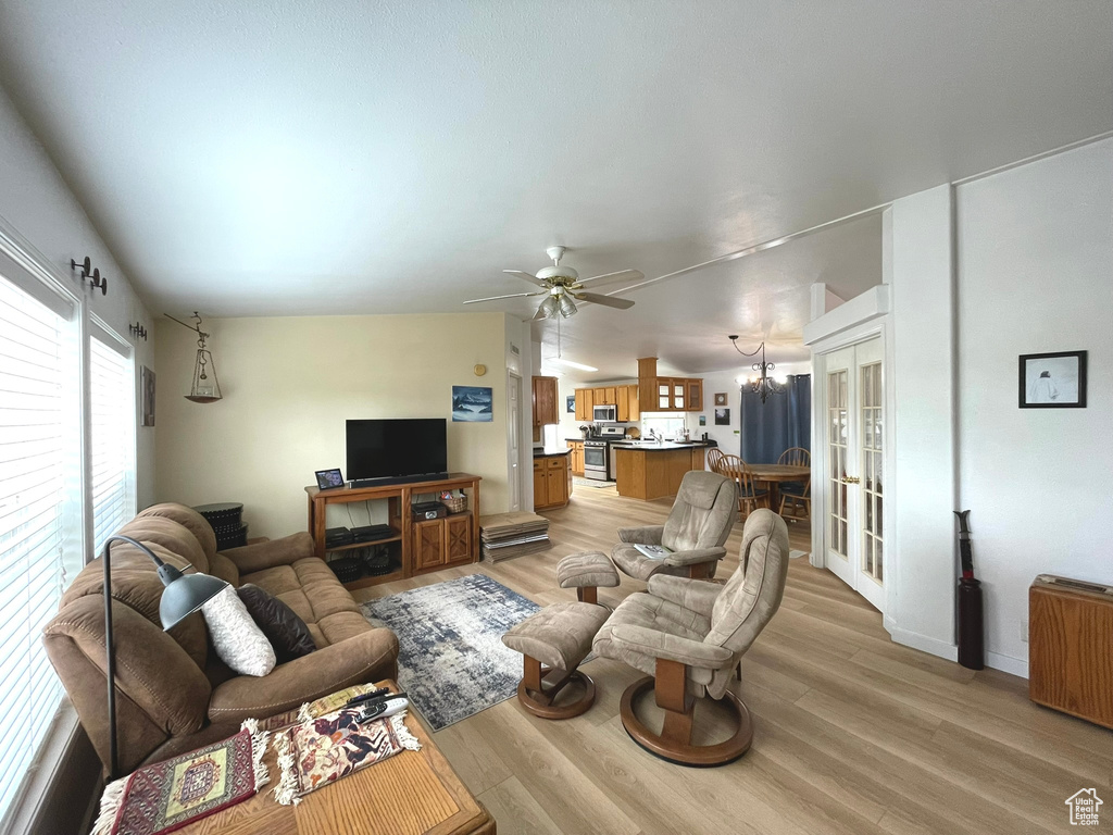 Living area featuring light wood-style floors, french doors, and ceiling fan