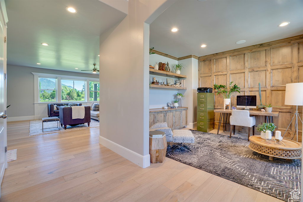 Home office featuring baseboards, recessed lighting, ceiling fan, light wood finished floors, and arched walkways