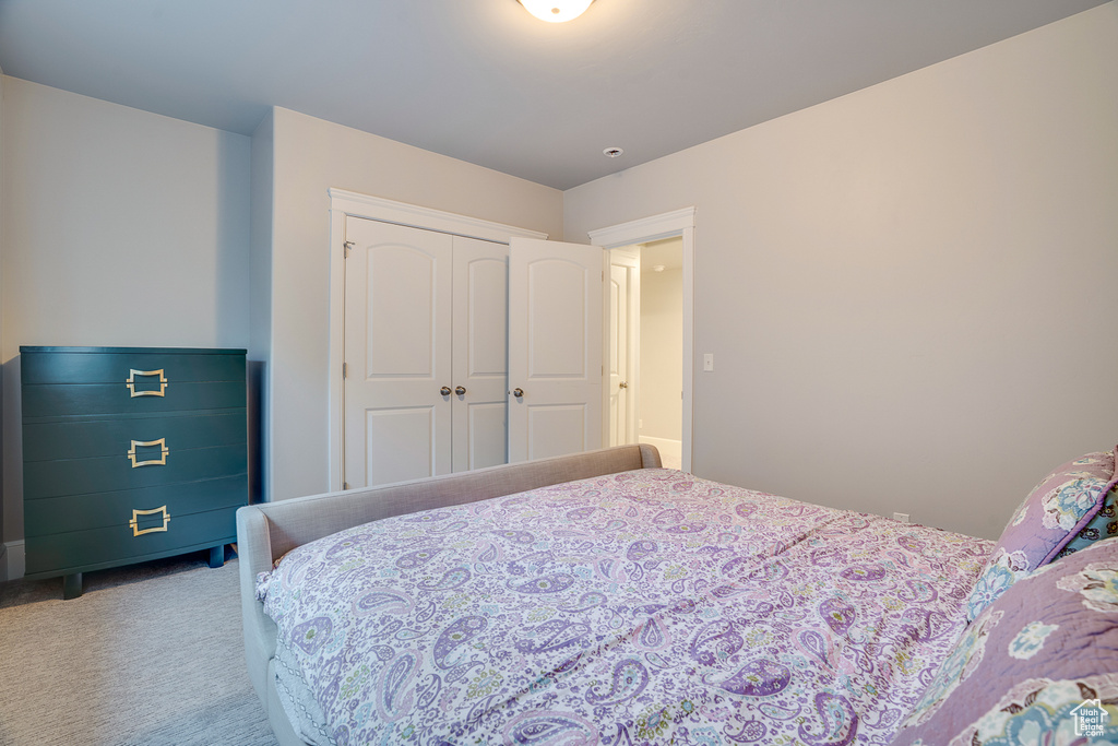 Bedroom featuring carpet flooring and a closet