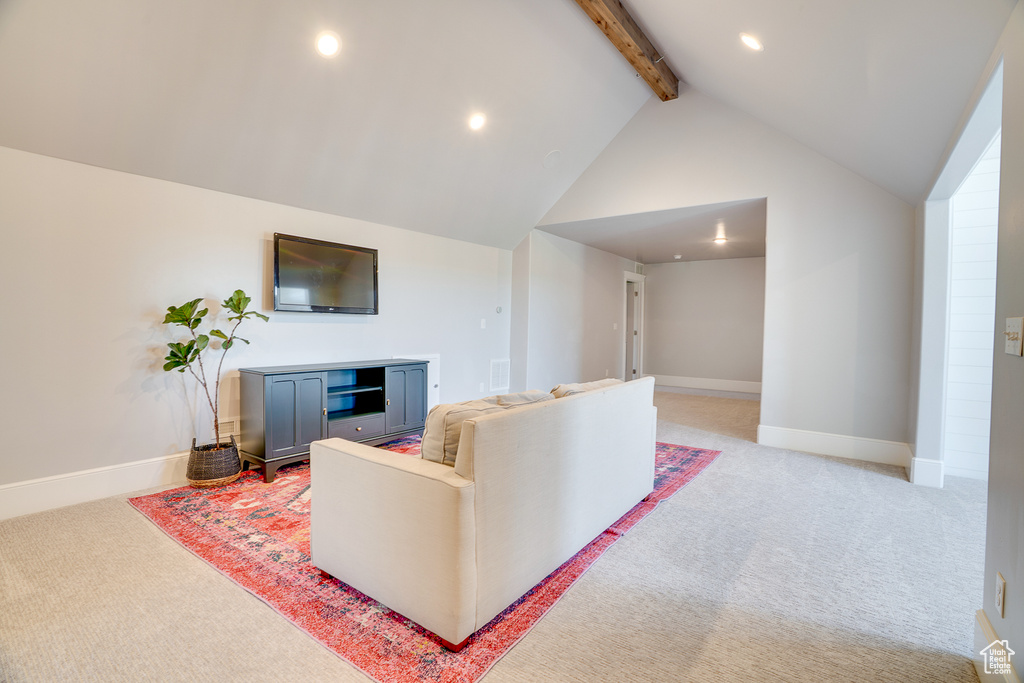 Living area with beam ceiling, light colored carpet, recessed lighting, baseboards, and high vaulted ceiling