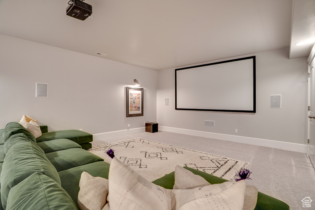 Home theater featuring baseboards and carpet