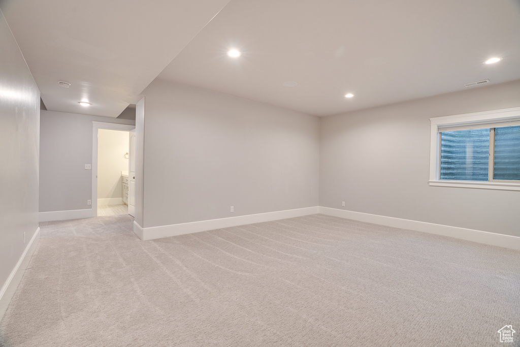 Spare room featuring light carpet, recessed lighting, and baseboards
