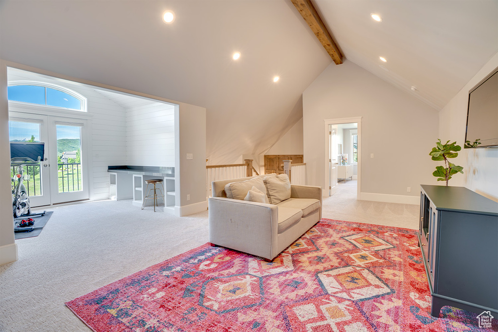Living room with light carpet, beamed ceiling, recessed lighting, high vaulted ceiling, and baseboards
