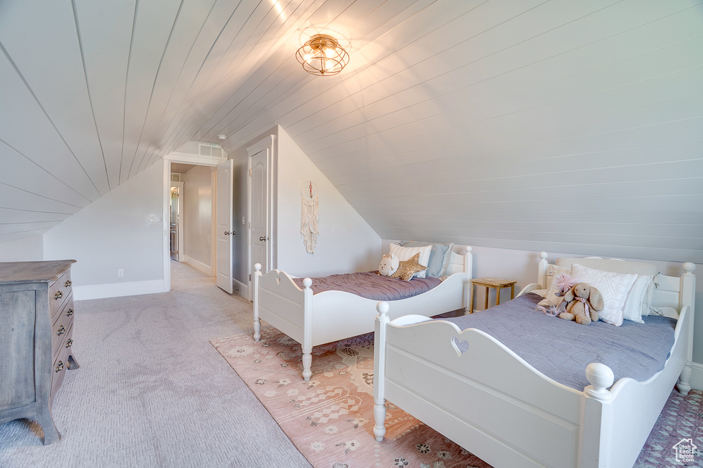Bedroom featuring light carpet, lofted ceiling, and wooden ceiling