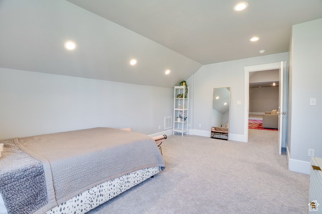 Carpeted bedroom with vaulted ceiling, recessed lighting, and baseboards
