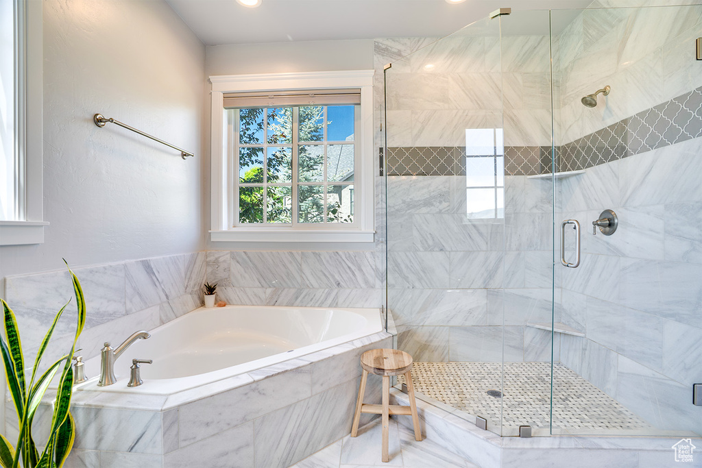 Bathroom with a bath and a shower stall
