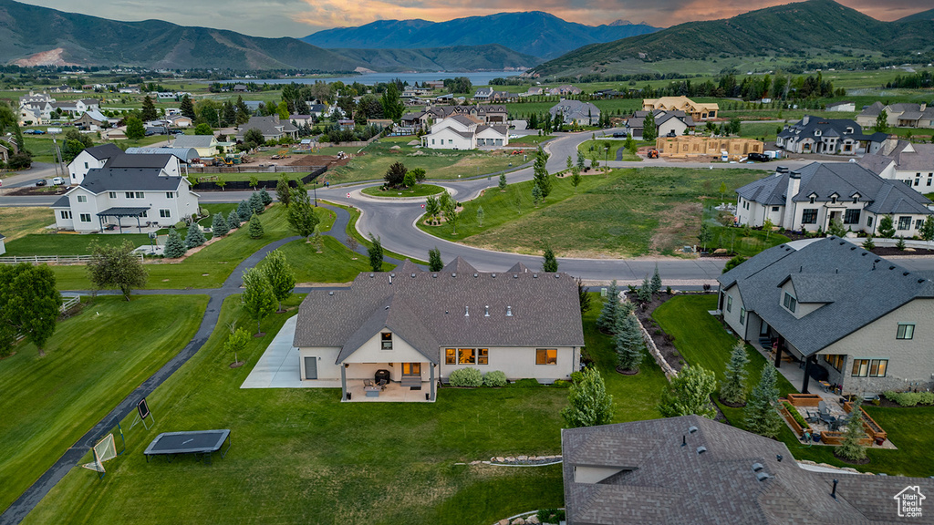 Aerial perspective of suburban area featuring a mountainous background