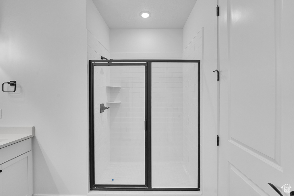Bathroom featuring vanity, a shower stall, and recessed lighting