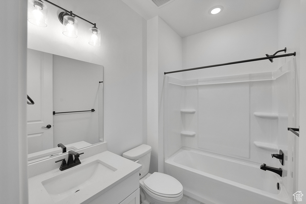 Full bath featuring vanity, shower / bathtub combination, toilet, and recessed lighting