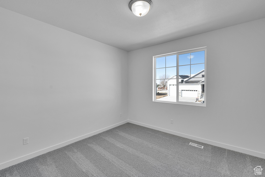 Unfurnished room featuring baseboards and carpet flooring