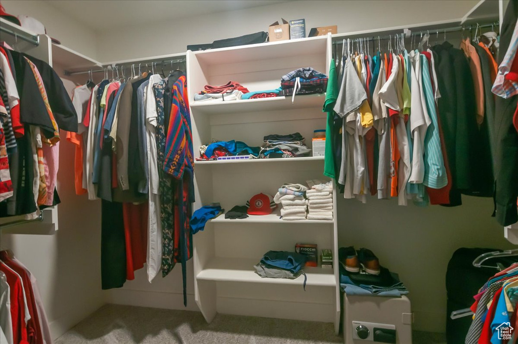 Walk in closet with carpet flooring