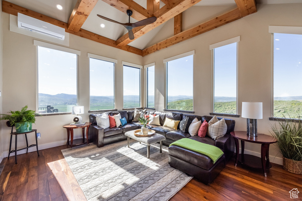 Sunroom / solarium featuring a wall mounted AC, healthy amount of natural light, hardwood / wood-style flooring, and recessed lighting