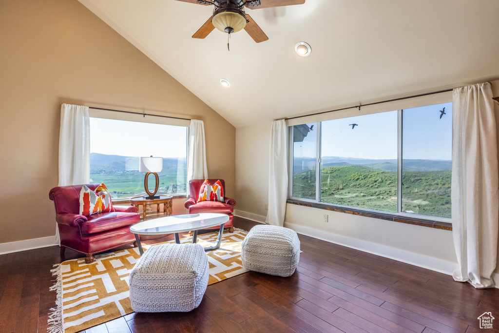 Sitting room with baseboards, wood finished floors, ceiling fan, lofted ceiling, and recessed lighting