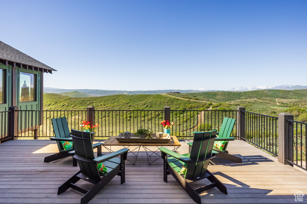 Wooden terrace featuring a mountain view