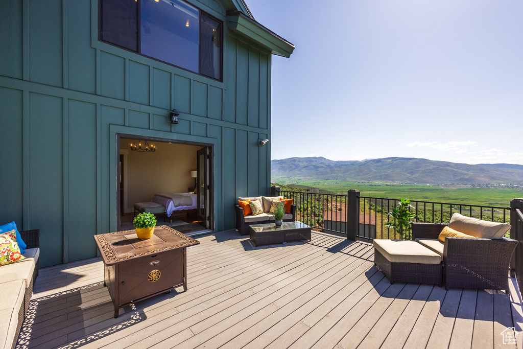 Wooden deck with a mountain view and an outdoor hangout area