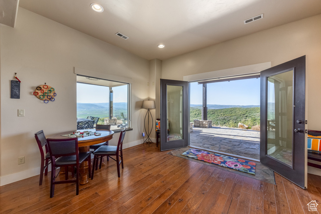 Dining room with wood finished floors, healthy amount of natural light, baseboards, and recessed lighting