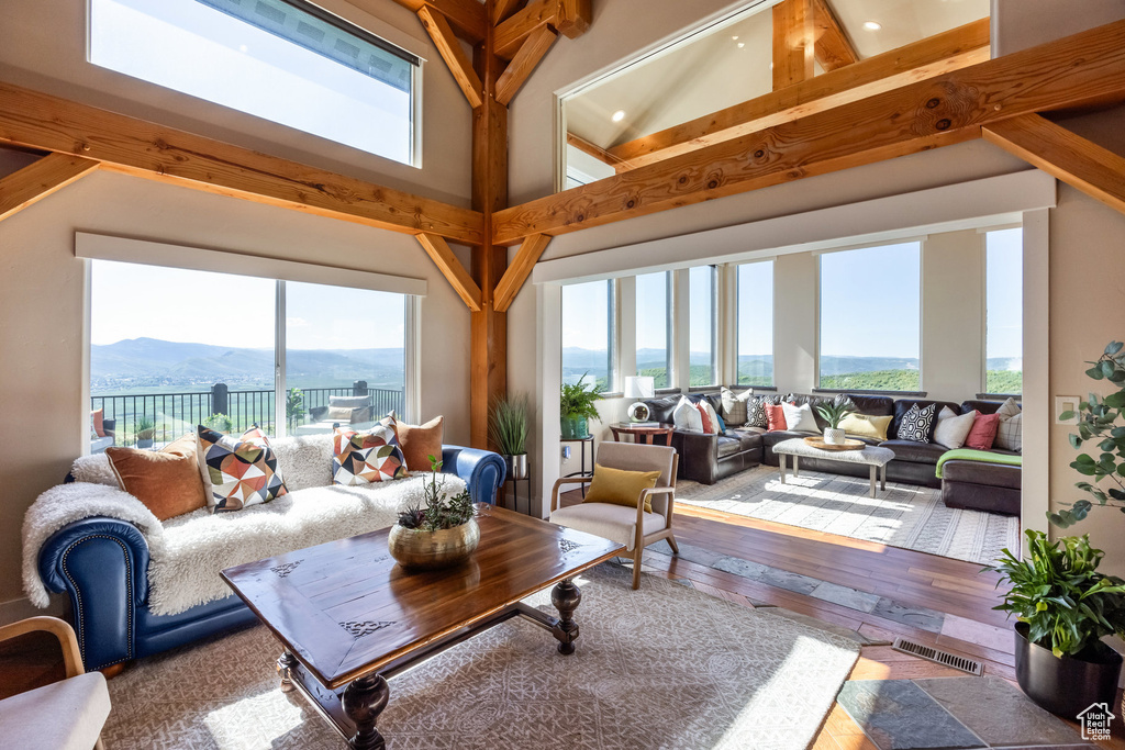 Living area with hardwood / wood-style floors, a mountain view, and plenty of natural light