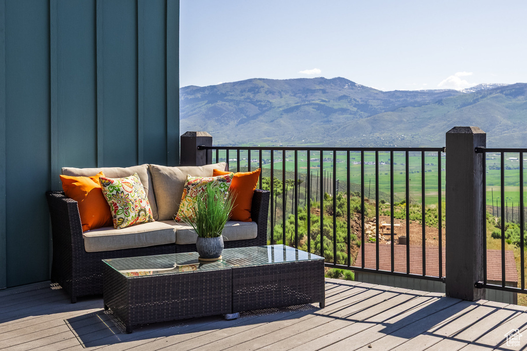 Wooden terrace with a mountain view and an outdoor living space