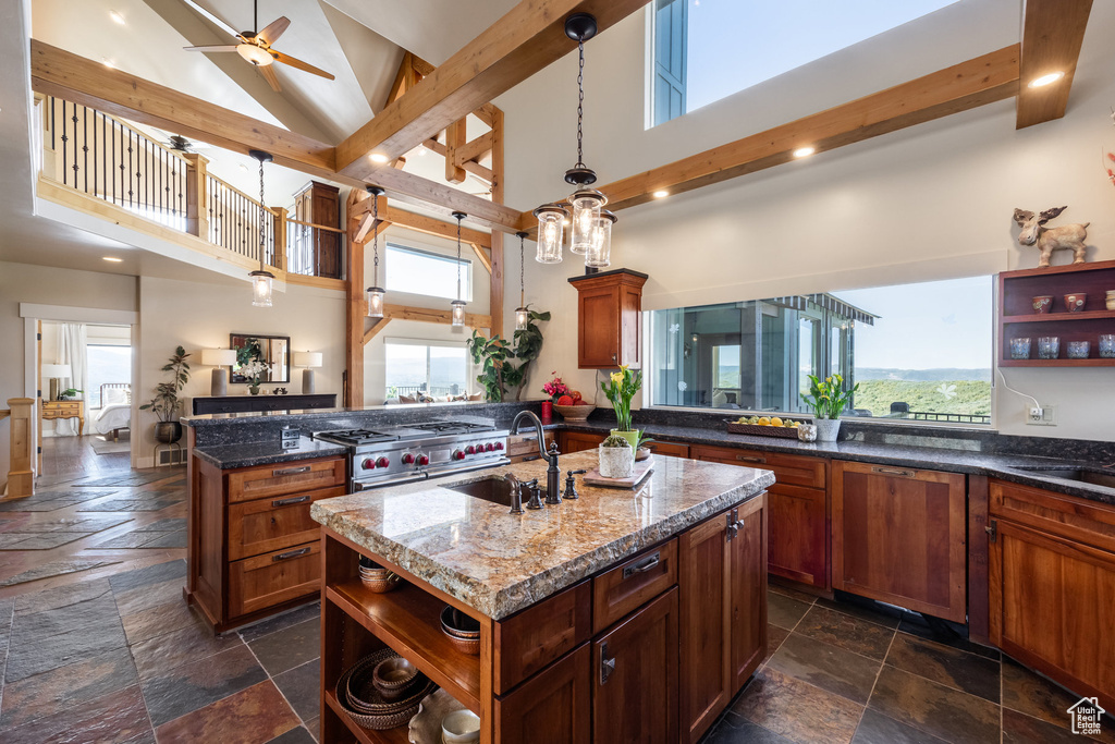 Kitchen featuring open shelves, a sink, stone tile floors, high vaulted ceiling, and plenty of natural light