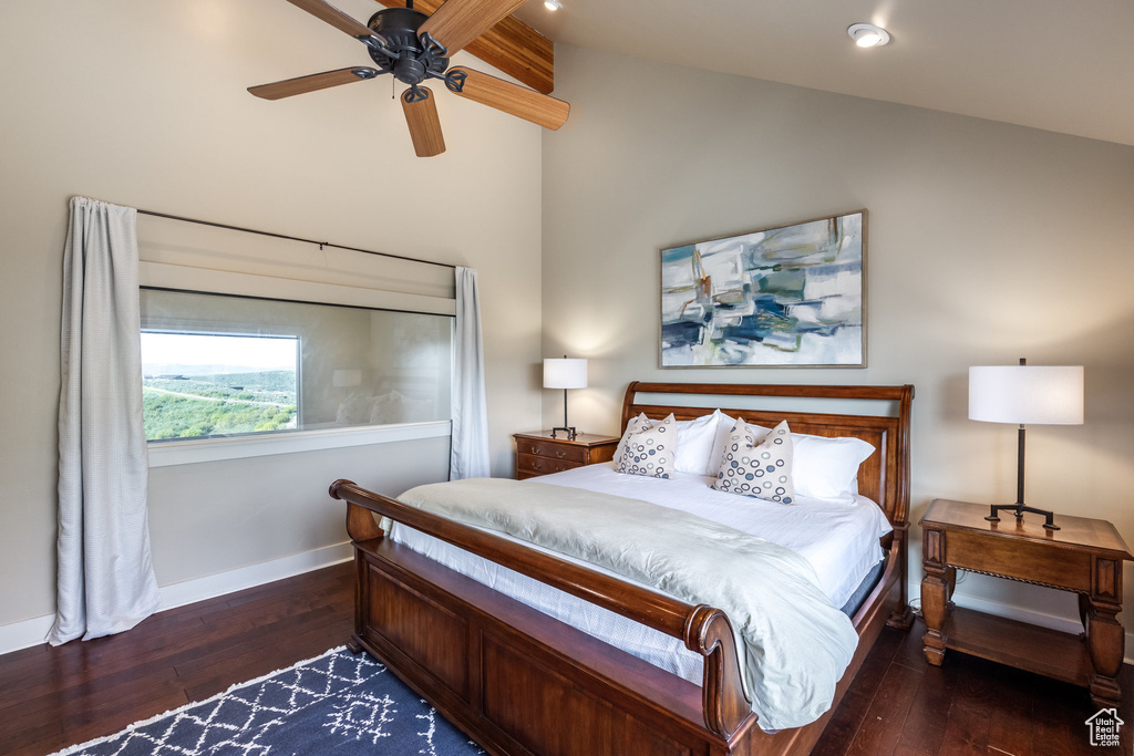 Bedroom with hardwood / wood-style floors, baseboards, and vaulted ceiling
