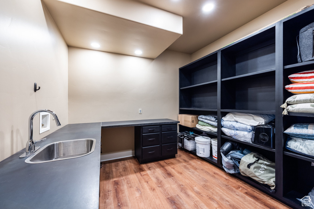 Office area with a sink and light wood-style flooring