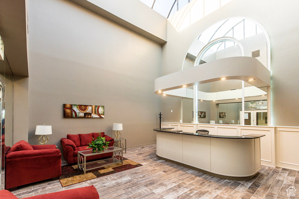 Interior space with a towering ceiling, wood finished floors, and vanity
