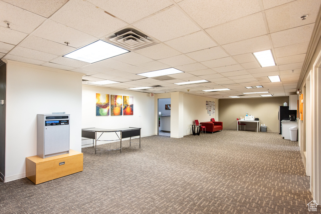 Game room with carpet, a paneled ceiling, and baseboards