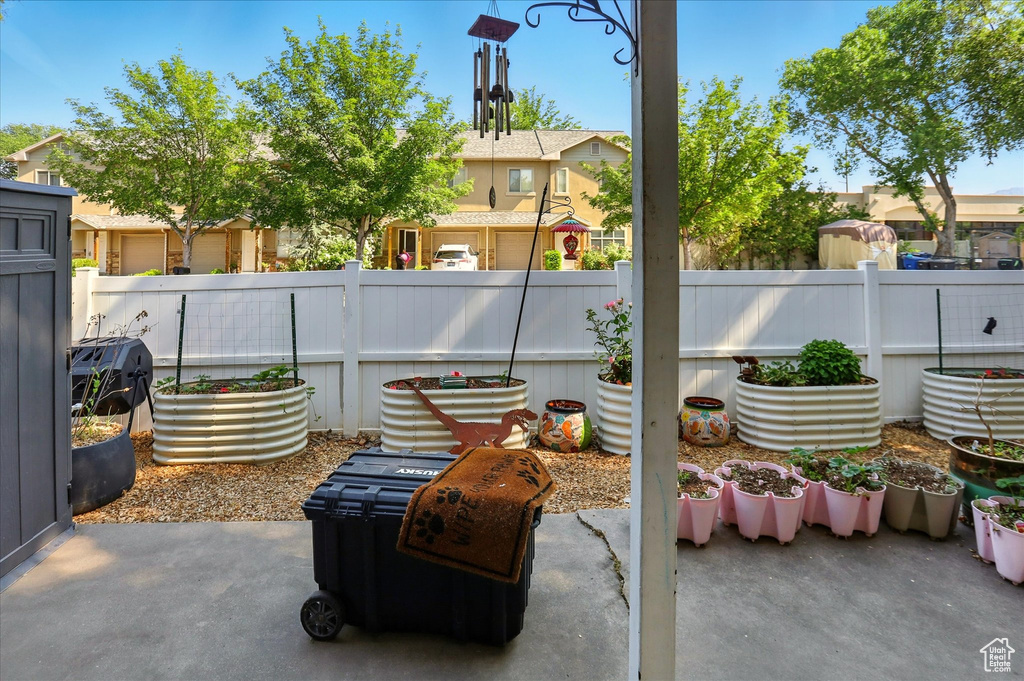 Fenced backyard with a patio area and a residential view