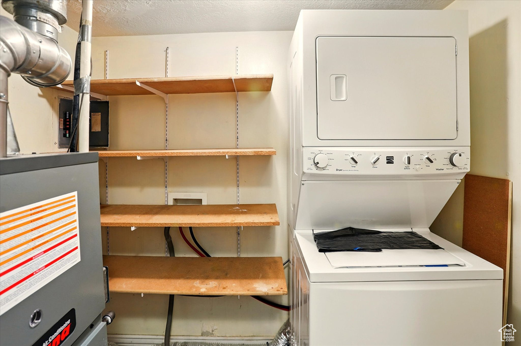 Laundry area with stacked washing machine and dryer